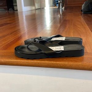 NWT Coach brand leather flip flops.  Size 7.  Black
